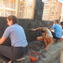 Some of our crew parging the outside wall of the construction project