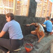 Some of our crew parging the outside wall of the construction project