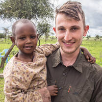 Volunteer carrying a baby