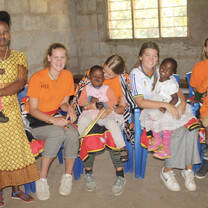 Volunteers and locals holding babies