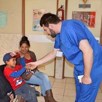 Medical volunteer giving hand to kid