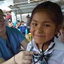 Medical volunteer with stethoscope on kid