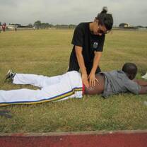 IVI volunteer giving physio treatment to athlete