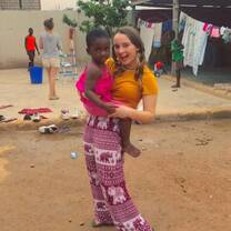 volunteer holding child on IVI project