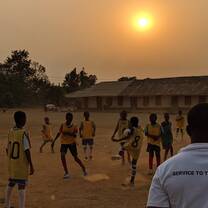 Football practice at sunset
