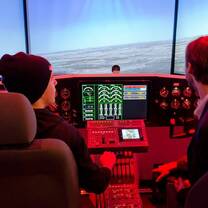 Students practice navigating a plane in the flight simulator.