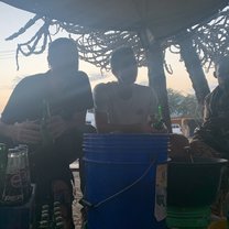 Drinking banana wine at sunset with the locals
