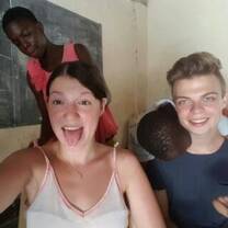 Volunteers and a student taken picture in the class