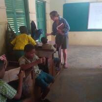 volunteer helping Class to understand  lessons given