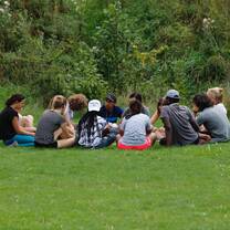 Participants in a circle outdoors 