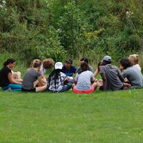 Participants in a circle outdoors 