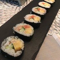 Sushi on a black rock slab plate