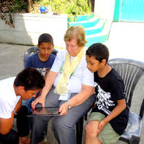 The boys at Buddhi Man's home reading stories to Fran. 