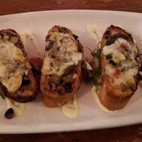 Crustini: Toasted sourdough bread, with sauteed mushrooms & vegetables, with cheese and a cream sauce