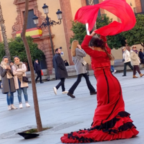 Flamenco dancing is well known in Seville. There are street performers that perform as you are walking down the street. This image is of a bailaora near a fountain in Seville and she is performing her own flamenco style. 
