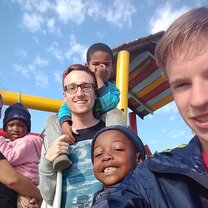 Picture of some of the volunteers with some of the children.
