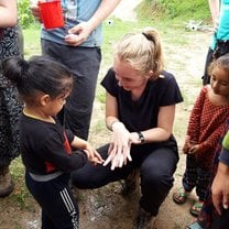 This is a picture of me teaching a little boy the 7 steps of hand washing during one of our community sessions. 