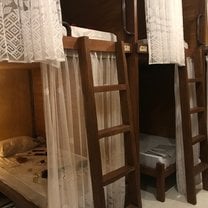 These were the nicer bedrooms. A small cabin with your bed, a small cabinet for storage inside and a lamp, with a mosquito net. Each room can sleep 6-10.