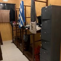 Storage space for belongings. It is an open shelf to place your suitcase on, and there is a lockable cabinet for valuables