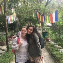 Two participants outside a temple