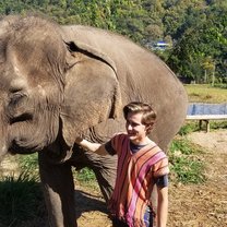 Petting an elephant during one of Global U's Adventure Weekend