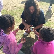 I was teaching these little girls how to play rock paper scissors 