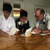 Tutor reading to children