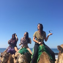 My friends and I riding camels.