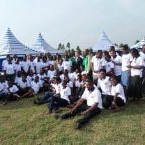 A  team of 4s volunteers posing posing for photo with South Korea Ambassador to Uganda 