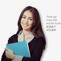 woman holding notebook and smiling in front of a white background