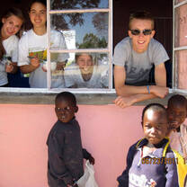 Volunteers look out from classroom