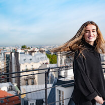 Student on a rooftop overlooking city