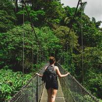 Student walking on hanging bridges in Costa Rican rainforest