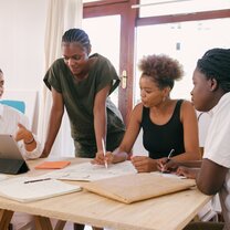International Interns on a meeting arouns the table
