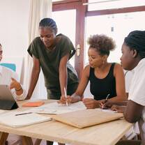 International Interns on a meeting arouns the table