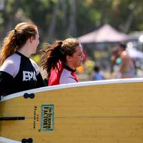 Students surf lessons at the beach