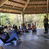 Group in gazebo learning, singing, smiling