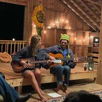 two people playing guitar