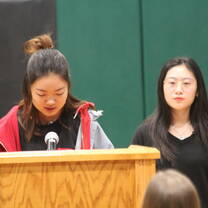 Students speaking during assembly