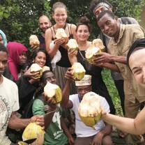 Volunteers and PDS members sharing coconuts