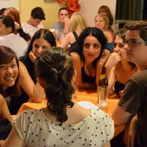Students sitting around tabels in the student lounge on campus