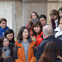 Participants on the front steps of the university building during an excursion