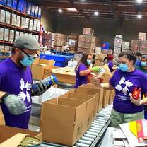 All Hands and Hearts Volunteers work at a local food bank