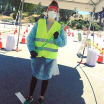 An All Hands and Hearts volunteer in protective equipment prepared to facilitate a COVID-19 test.