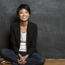 Teacher in Hong Kong in front of a blackboard