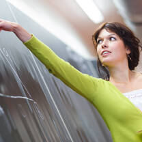 woman writing on blackboard