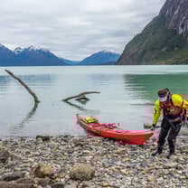 A student brings her sea kayak ashore