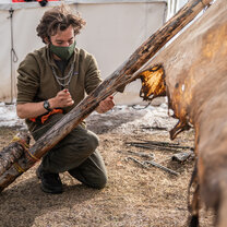 Learning how to tan a hide.  Visions participant helps treat a buffalo hide.