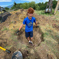 Montana farm and ranch participant digs a hole. 
