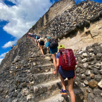 Students climb up the steps at the Mayan ruins at Xunantunich.